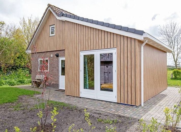 Vacation home 5 Persoons in Den Burg Texel with charming terrace and green surroundings.