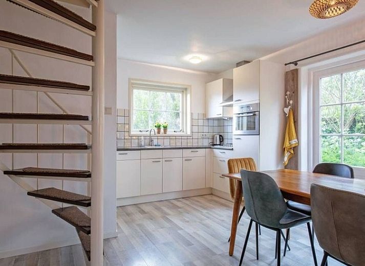 Vacation home 5 Persoons in Den Burg Texel with charming terrace and green surroundings.