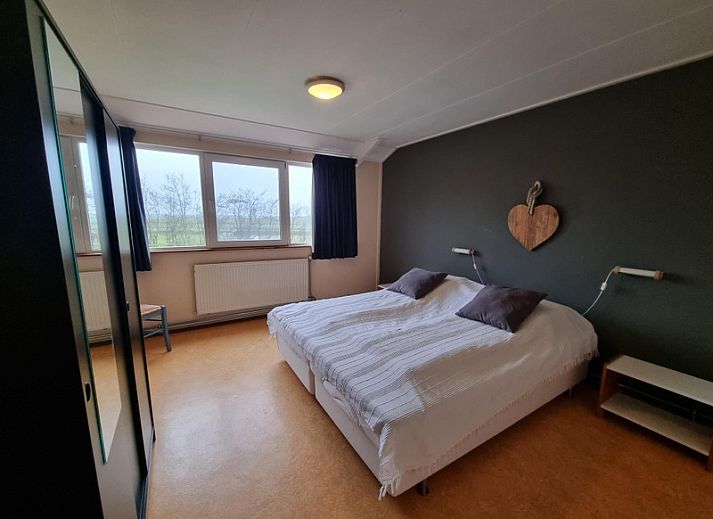 Veranda of Holiday home Westzicht in Den Burg Texel with green surroundings.