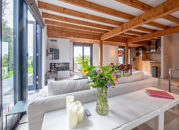 Modern interior of Buitenplaats vacation home in Den Burg Texel with wooden beamed ceiling.