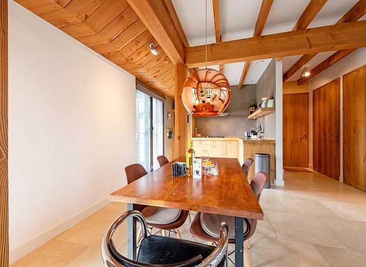 Modern interior of Buitenplaats vacation home in Den Burg Texel with wooden beamed ceiling.