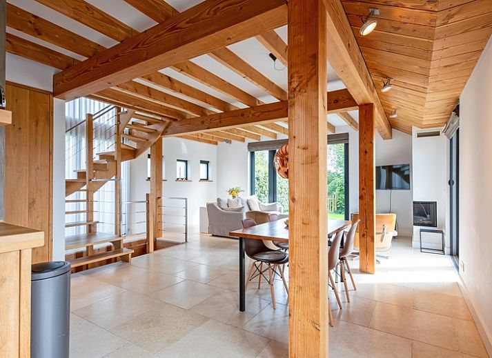 Modern interior of Buitenplaats vacation home in Den Burg Texel with wooden beamed ceiling.