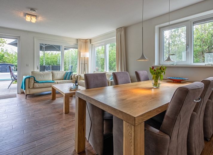 Sunny terrace at Villa 3C in Den Burg, Texel overlooking the pool, perfect for a relaxing vacation.