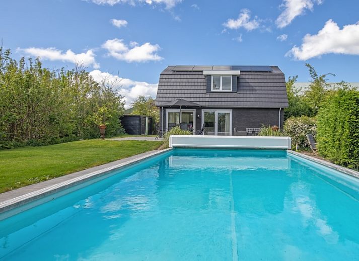 Sunny terrace at Villa 3C in Den Burg, Texel overlooking the pool, perfect for a relaxing vacation.