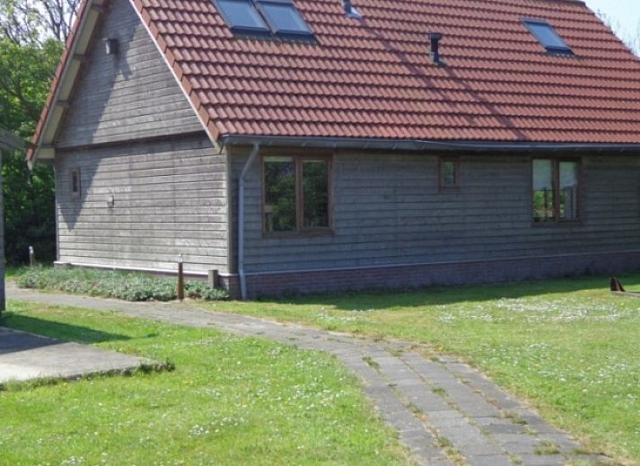 Ferienhaus Duinzicht in Den Burg Texel mit charmanter Holzfassade und gruener Umgebung.