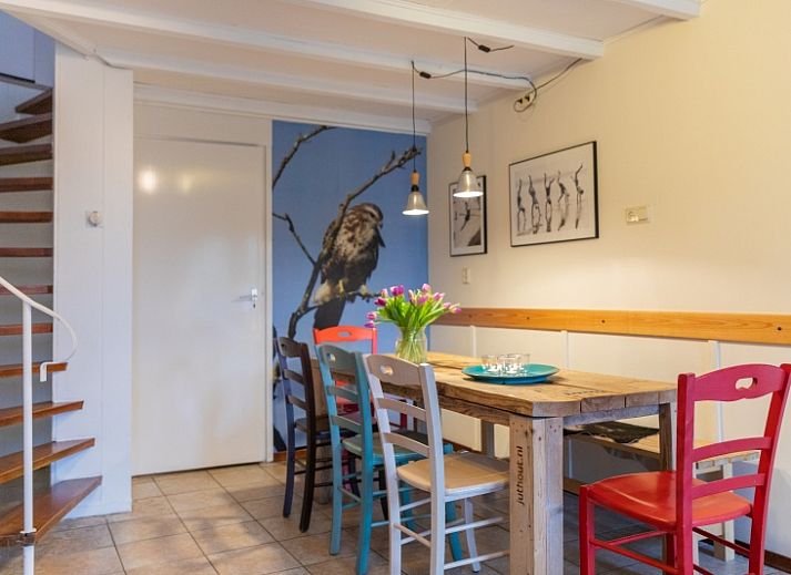 Charmantes Ferienhaus Schaapskooi in Den Hoorn, Texel, mit gruener Fassade und umliegender Natur.