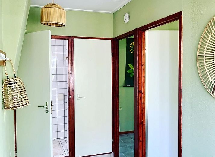 Gemuetlicher Innenbereich des Ferienhauses Vogelsand in Den Hoorn Texel mit Sitzecke und Essbereich.