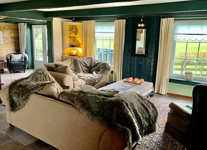 Cozy veranda at Holiday home in Oosterend, Texel, with comfortable seating and views of the garden.