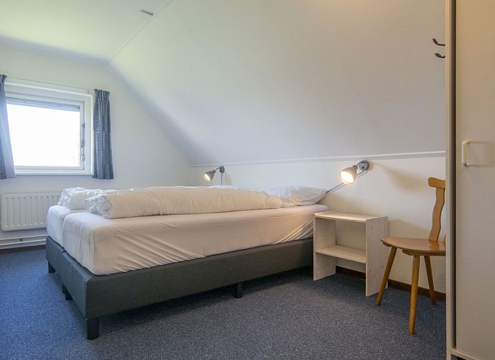 Gemuetliches Wohnzimmer im Ferienhaus Nieuwlanderweg 69, De Koog, Texel mit komfortabler Sitzecke, Wadden Islands.