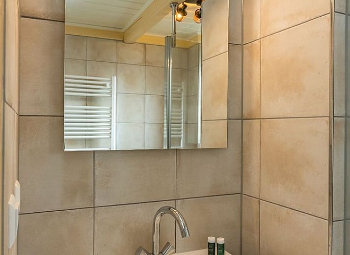 Open living space in Holiday home in Oosterend, Texel, with wood stove and dining area.