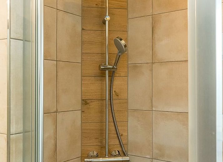 Open living space in Holiday home in Oosterend, Texel, with wood stove and dining area.