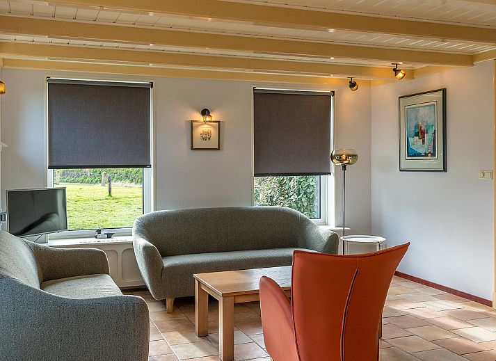 Golden Rider vacation home in Oosterend, Texel with traditional architecture and thatched roof.