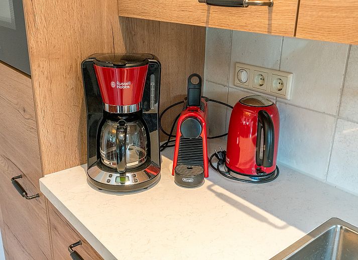 Cozy living room of Gouden Rijder vacation home in Oosterend, Texel with comfortable seating area.