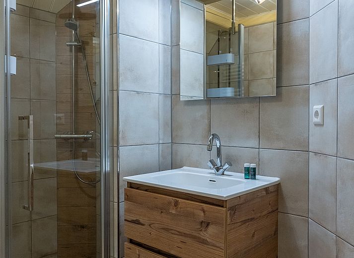 Modern living room of Zilverling vacation home in Oosterend, Texel overlooking the terrace.