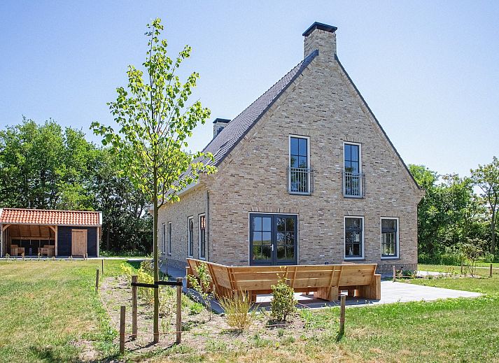 Vakantiehuis 46 - Nieuw Zeeland in Oosterend, Texel, met groene omgeving en zonnige veranda.