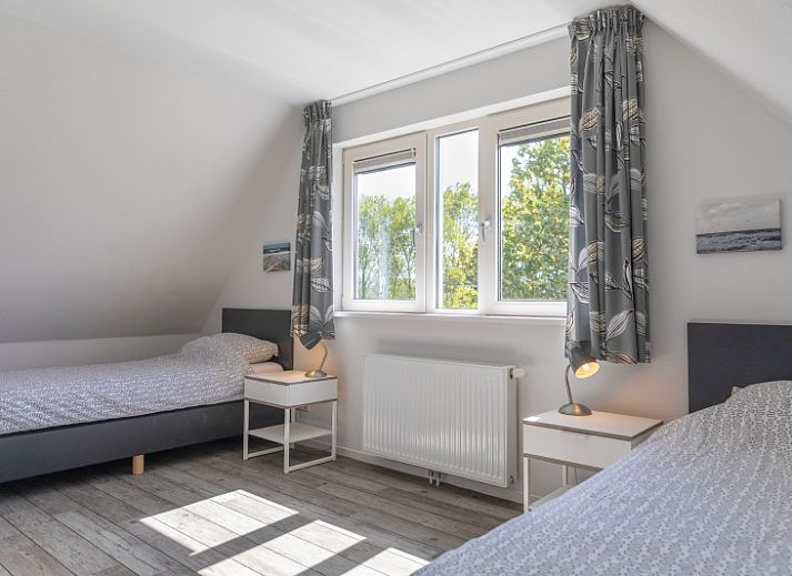 Gemuetliches Wohnzimmer des Ferienhauses Lucrosa in Oosterend Texel mit bequemer Sitzecke.