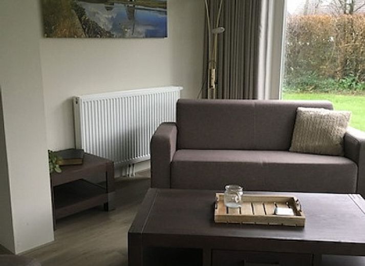 Exterior of vacation home Vuurtoren in Oosterend, Texel with spacious veranda and green surroundings.