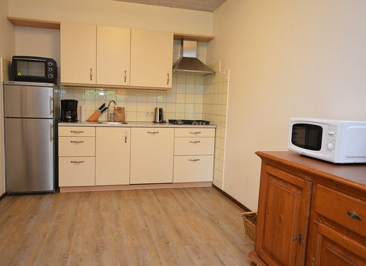 Cozy living room of vacation home Narcis, De Dennen, Texel with comfortable seating area.