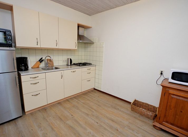 Cozy living room of vacation home Narcis, De Dennen, Texel with comfortable seating area.