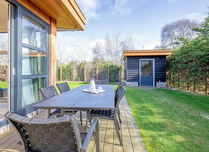 Vakantiehuis De Vlinder in Bungalowpark 't Hoogelandt op Texel biedt een ruime veranda met zitgelegenheid in de natuur van De Dennen.