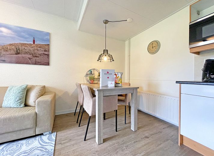 Stylish living area of Apartment Bos en Duin 14, De Dennen, Texel with modern furnishings and dining area.