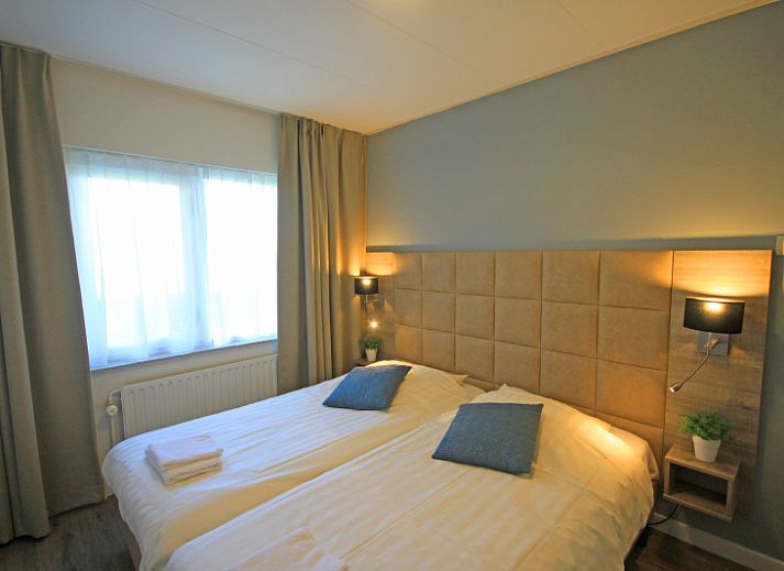 Stylish living area of Apartment Bos en Duin 14, De Dennen, Texel with modern furnishings and dining area.