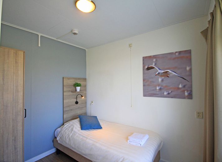 Stylish living area of Apartment Bos en Duin 14, De Dennen, Texel with modern furnishings and dining area.