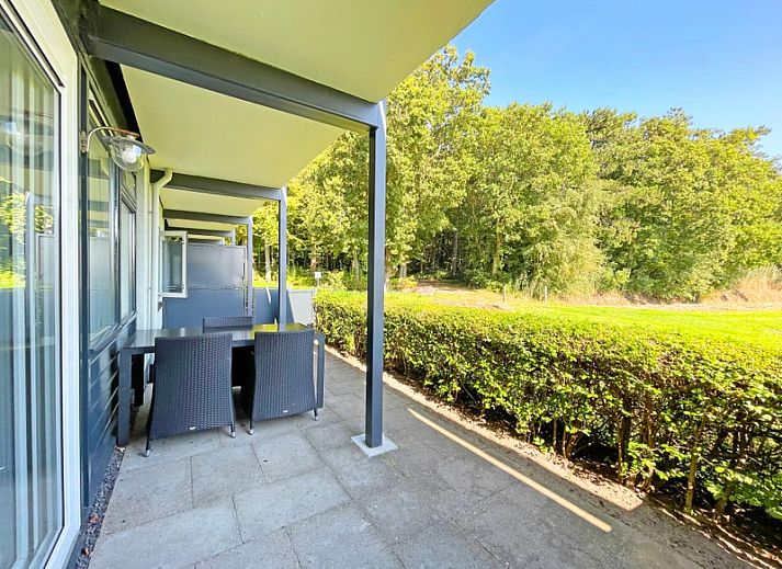 Stylish living area of Apartment Bos en Duin 14, De Dennen, Texel with modern furnishings and dining area.