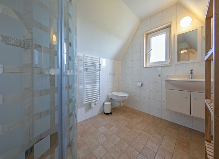 Gemuetliches Wohnzimmer von Cottage 6 in De Dennen, Texel mit Blick auf den Garten.