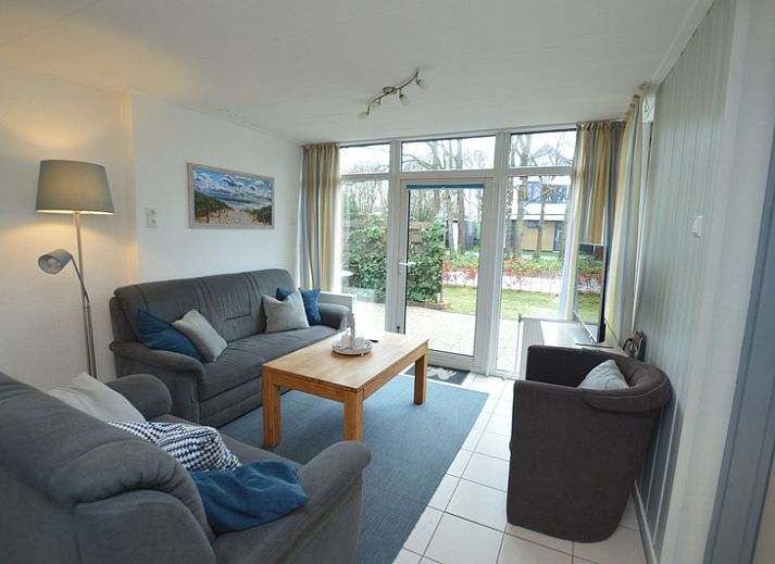 Ferienhaus de Parel 194 in De Dennen, Texel mit sonniger Terrasse und gruener Umgebung.