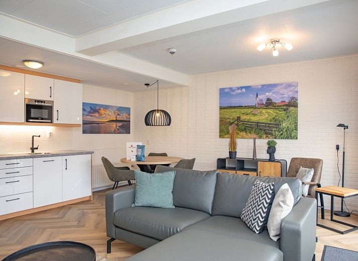 Gezellige woonkamer van Appartement Bos en Duin 28 in De Dennen, Texel, met comfortabel zitgedeelte en uitzicht op de natuur.