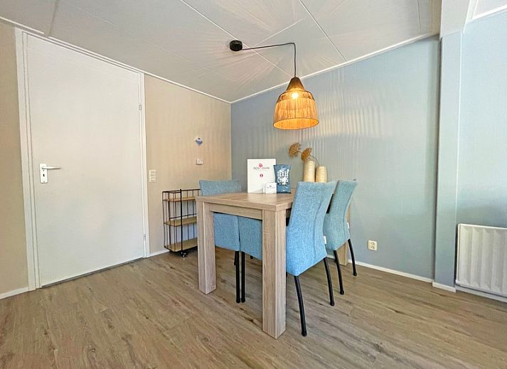 Cozy living room in Apartment Bos en Duin 22, De Dennen, Texel with comfortable furniture and large windows.