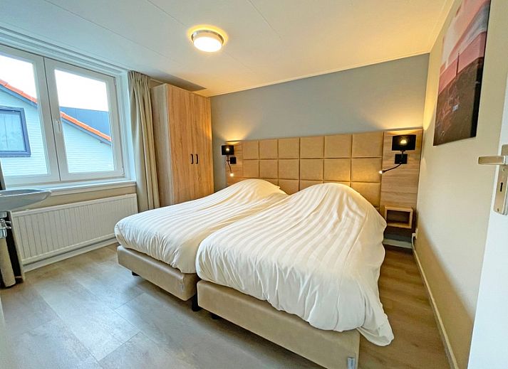 Spacious sitting area in Apartment Bos en Duin 22, De Dennen, Texel overlooking the green surroundings.