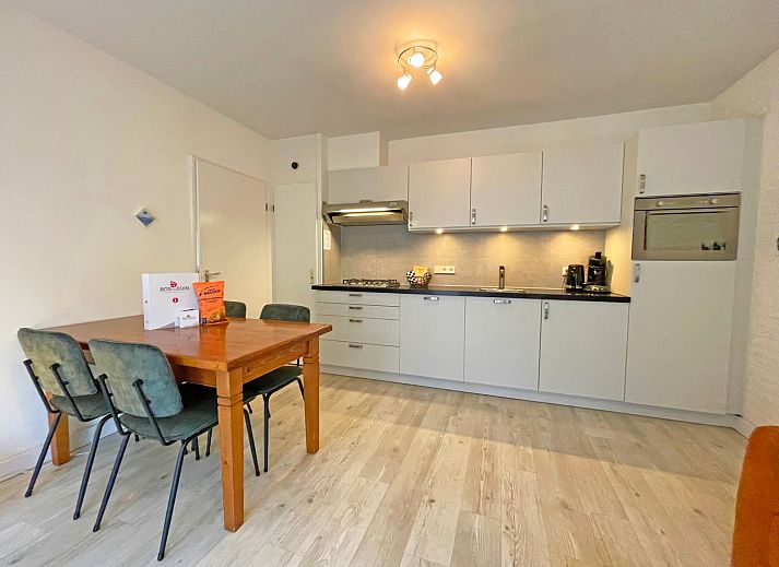 Cozy sitting area in Apartment Bos en Duin 08, De Dennen, Texel, overlooking the green surroundings.