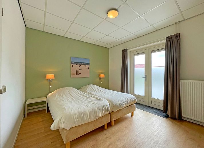 Cozy sitting area in Apartment Bos en Duin 08, De Dennen, Texel, overlooking the green surroundings.