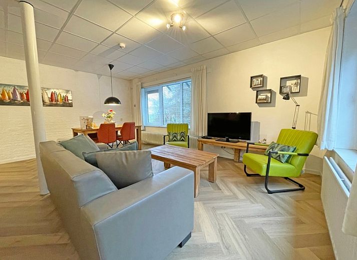Cozy living room in Apartment Bos en Duin 04, De Dennen, Texel with comfortable seating area and large windows.