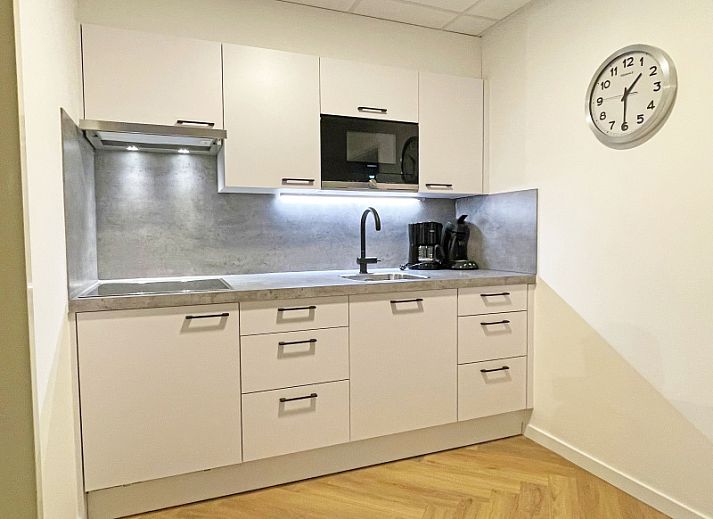 Cozy living room in Apartment Bos en Duin 04, De Dennen, Texel with comfortable seating area and large windows.