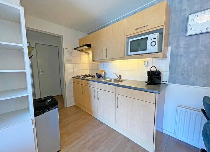 Stilvolle Sitzecke im Apartment Bos en Duin 11, De Dennen Texel mit bequemen Sofas und Gartenblick.