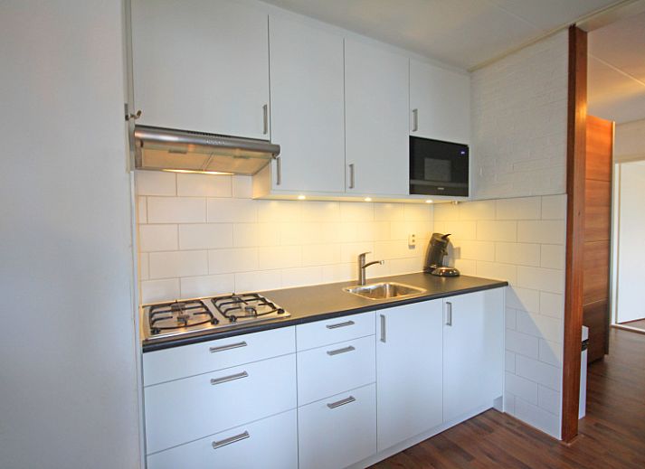 Cozy living room in Apartment Bos en Duin 33, De Dennen, Texel with modern decor and lots of natural light.