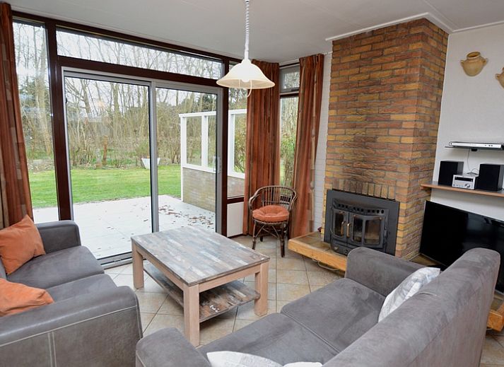 Vakantiehuis de Parel 160 in De Dennen, Texel, biedt een charmante buitenruimte met een zonnig terras en weelderige tuin.