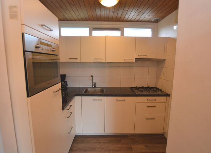 Gezellige woonkamer in Vakantiehuis de Parel 234, De Dennen, Texel met uitzicht op de tuin.