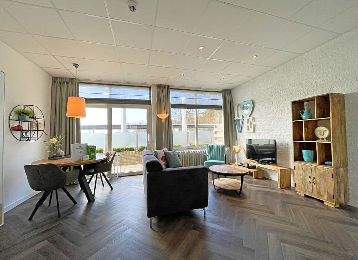 Apartment Bos en Duin 02 in De Dennen, Texel offers a spacious living room with modern interior and plenty of natural light.