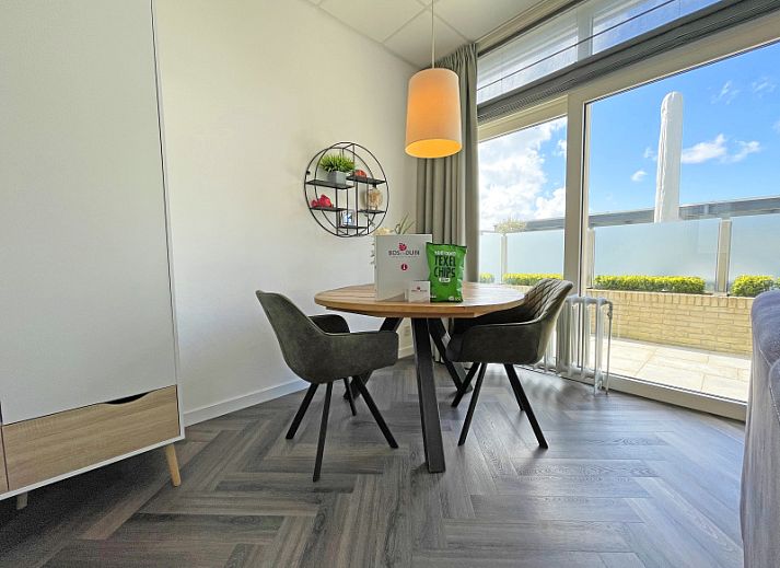Apartment Bos en Duin 02 in De Dennen, Texel offers a spacious living room with modern interior and plenty of natural light.