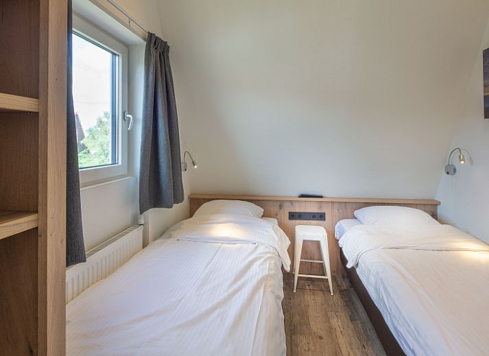 Gezellige woonkamer in vakantiehuis Gortersmient 224, Bungalowpark Gortersmient, De Dennen, Texel. Ideaal voor ontspanning op de Waddeneilanden.