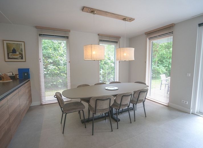 Cozy living room in Holiday home de Parel 180, De Dennen, Texel, overlooking the garden.
