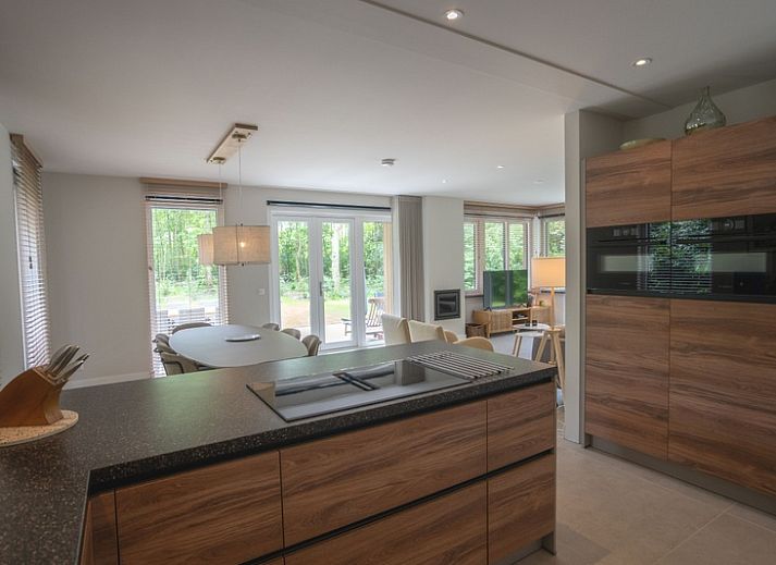 Cozy living room in Holiday home de Parel 180, De Dennen, Texel, overlooking the garden.