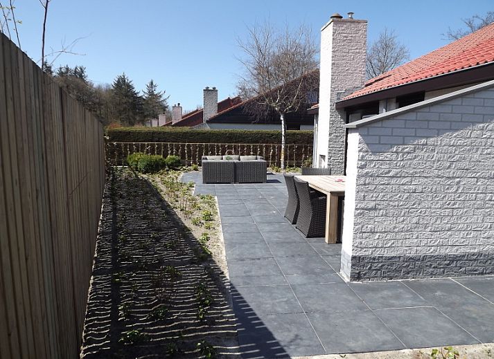 Vakantiehuis Gortersmient 320 in De Dennen, Texel met ruim terras en moderne buitenmeubels, ideaal voor ontspanning op de Waddeneilanden.