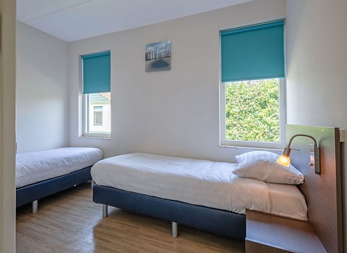 Cozy terrace at Type 2 - 4 person vacation home in De Dennen, Texel, with children playing in the garden.