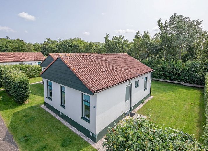 Cozy terrace at Type 2 - 4 person vacation home in De Dennen, Texel, with children playing in the garden.