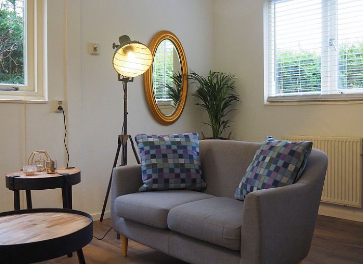 Cozy terrace at Duinpieper vacation home in De Dennen, Texel, surrounded by nature.